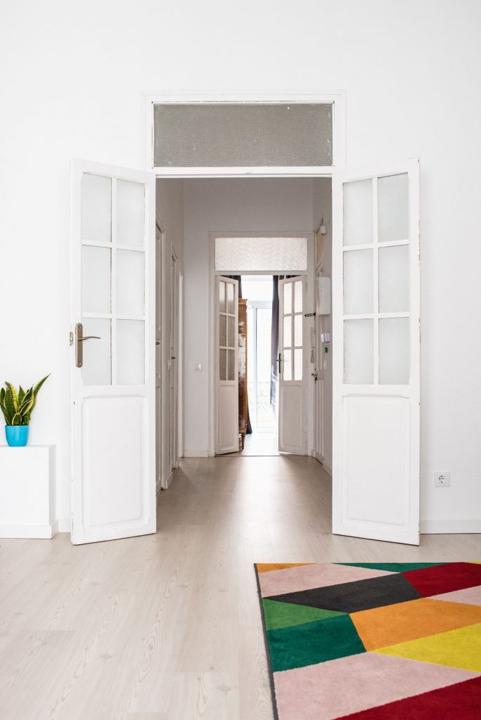 Hallways with wood flooring and light walls.